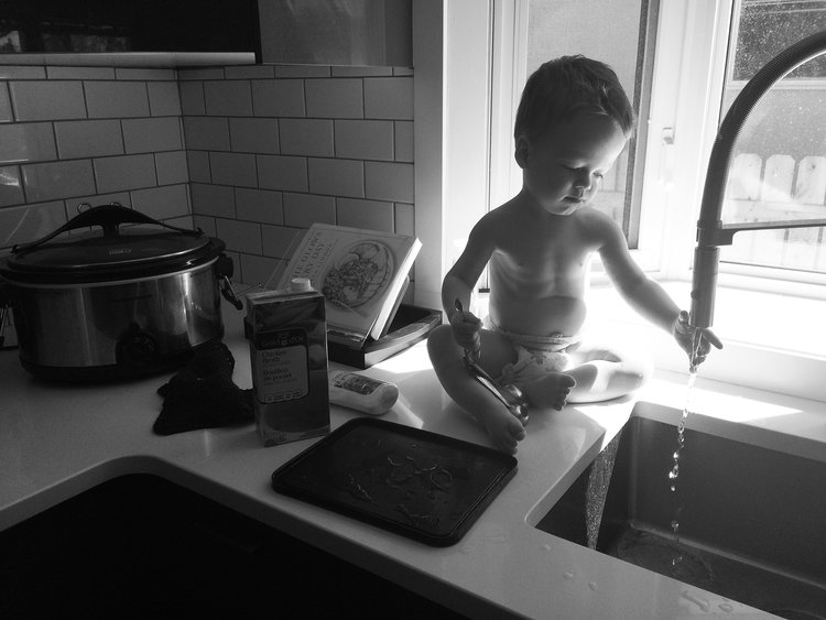 kid playing in the sink